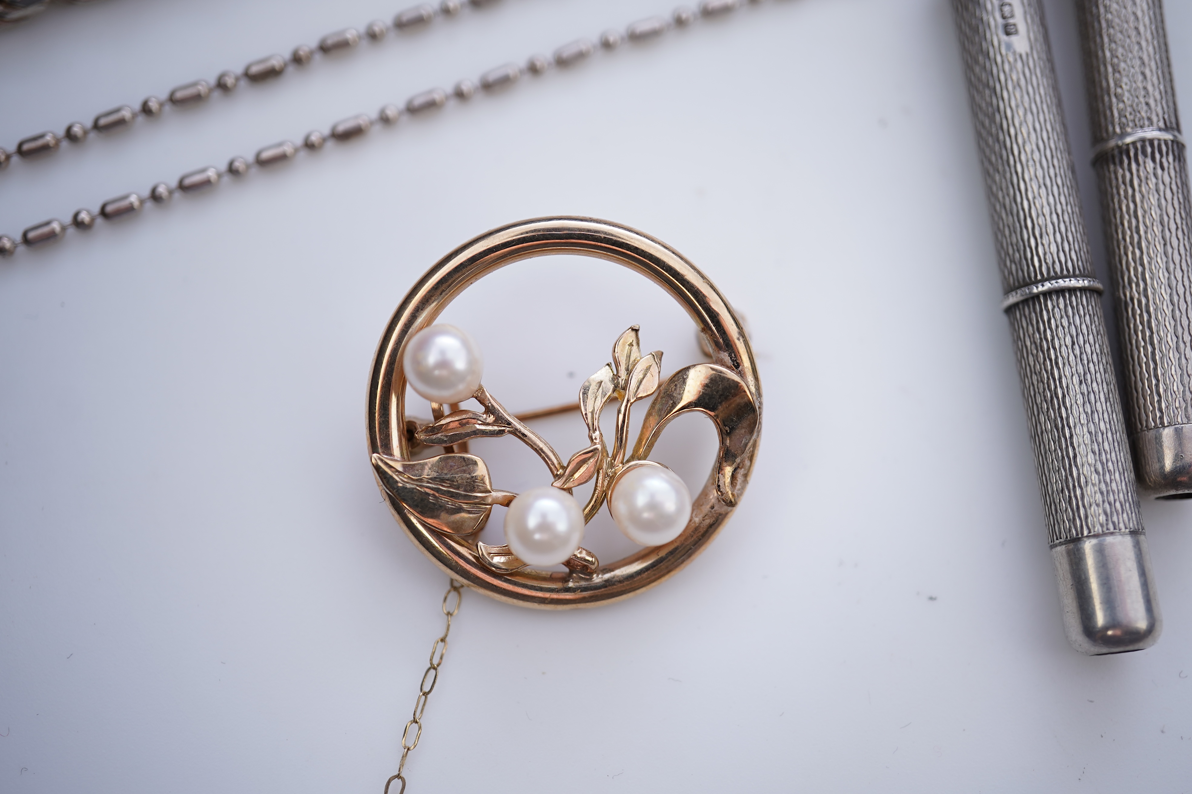 A collection of silver jewels, comprising: a bangle; a chain necklace suspending two winding toothpicks, one with toothpick deficient; a rope twist chain; a pair of cufflinks with the initials DBH; a pendant of abstract